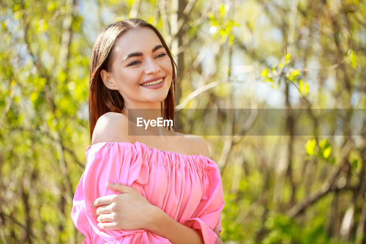 Beautiful young woman with a well-groomed face on a natural background