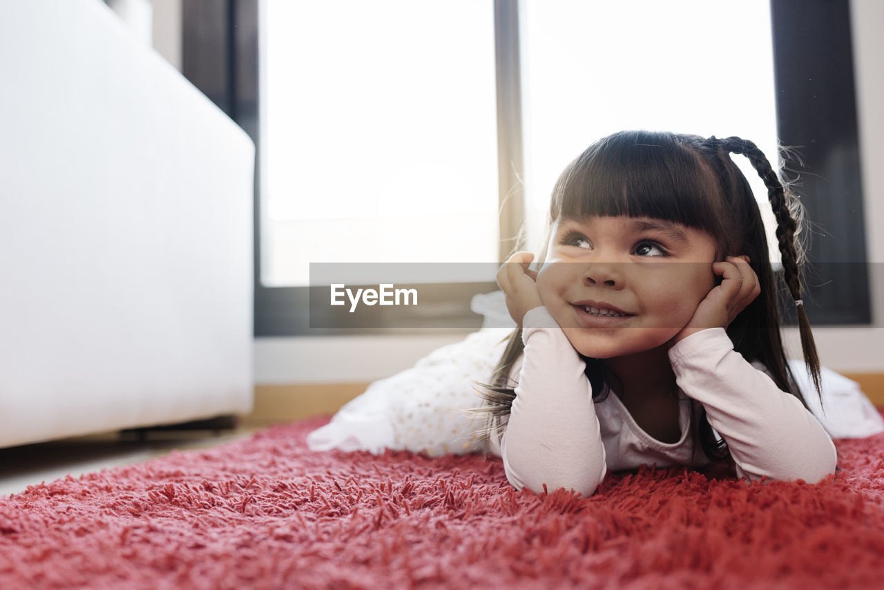 PORTRAIT OF CUTE SMILING GIRL AT HOME