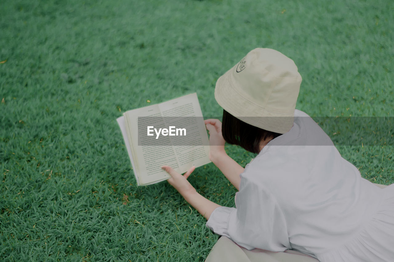 Rear view of woman reading book