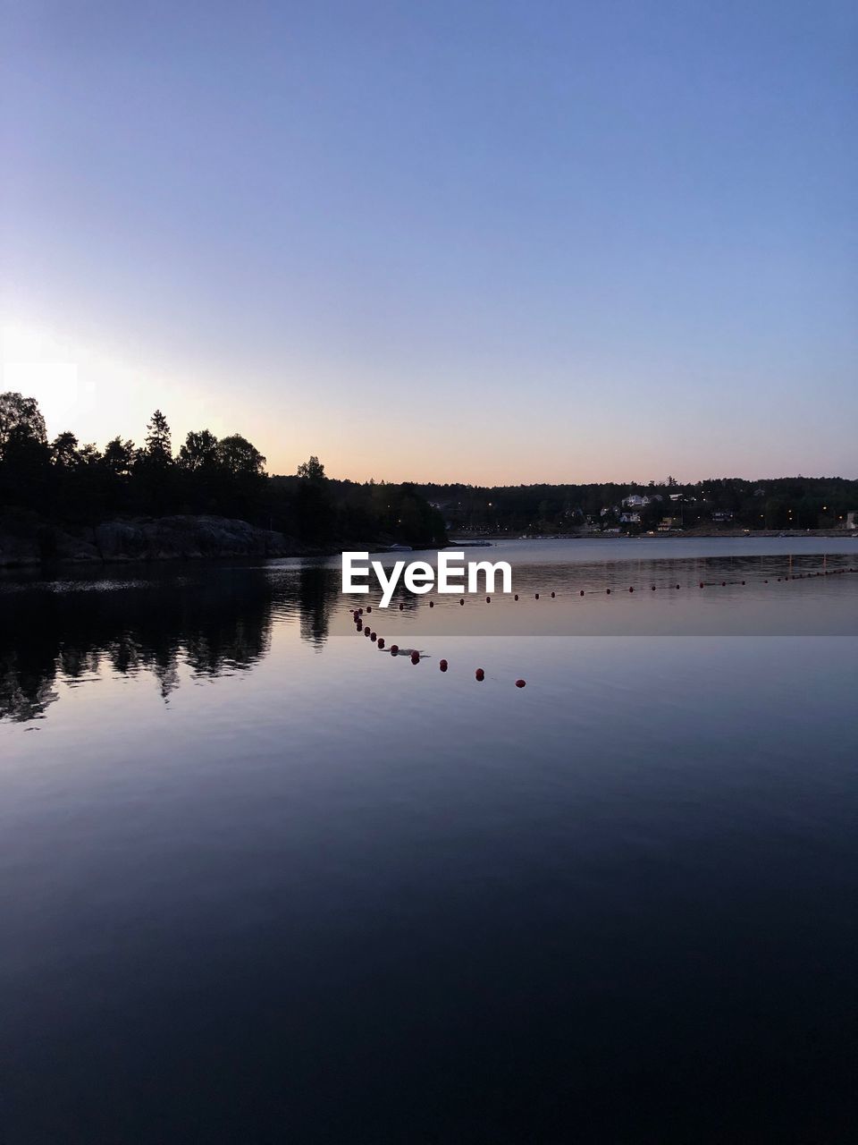 SCENIC VIEW OF LAKE AGAINST SKY AT SUNSET