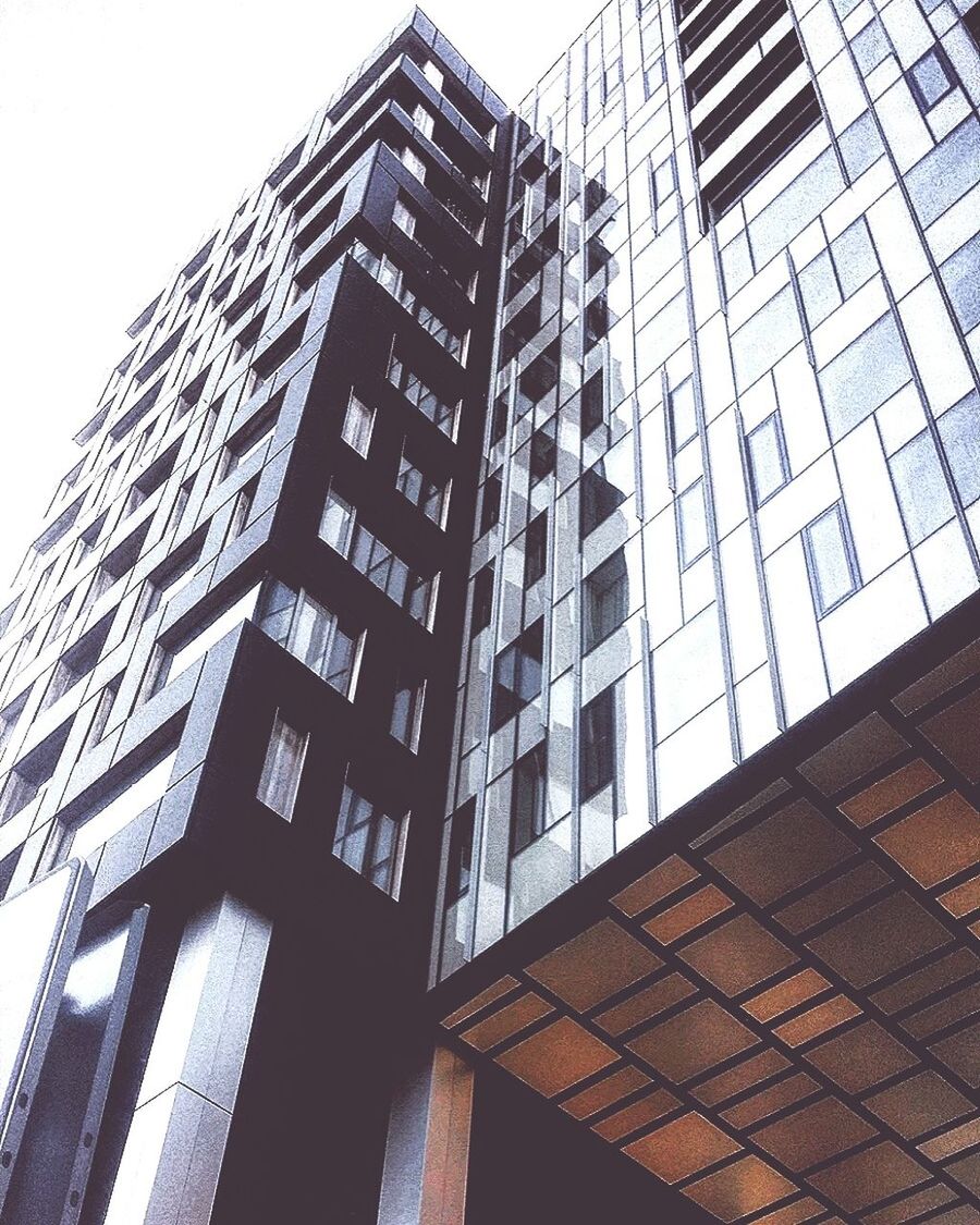 LOW ANGLE VIEW OF OFFICE BUILDING AGAINST CLEAR SKY