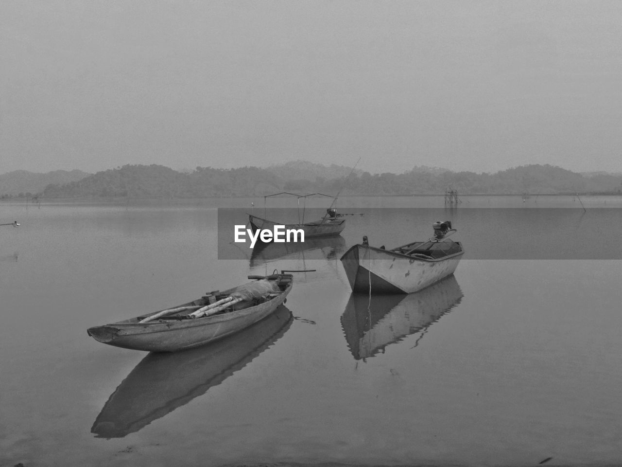 Boats on river against sky