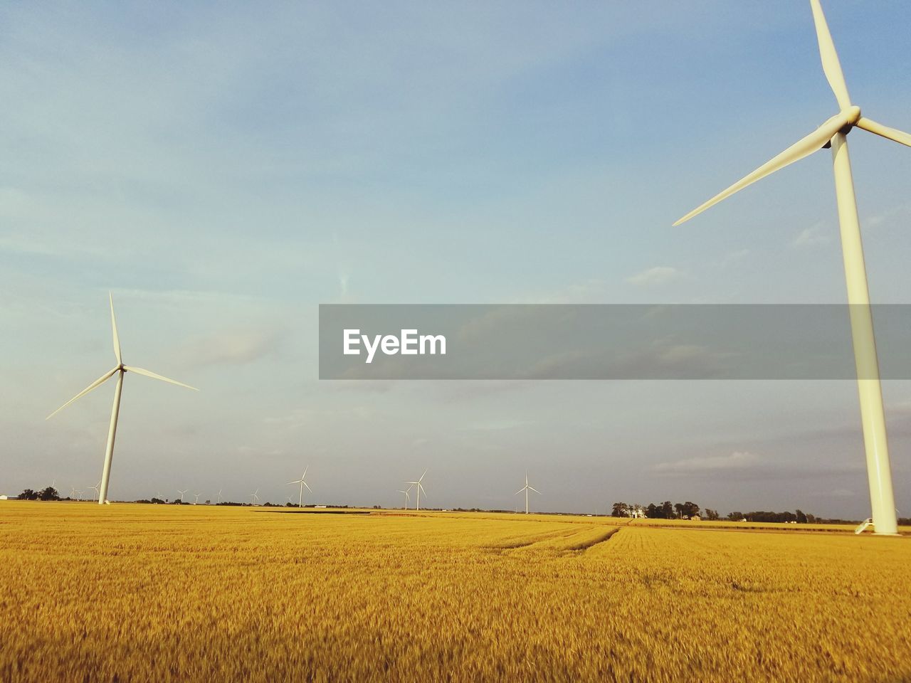 TRADITIONAL WINDMILL ON FIELD AGAINST SKY