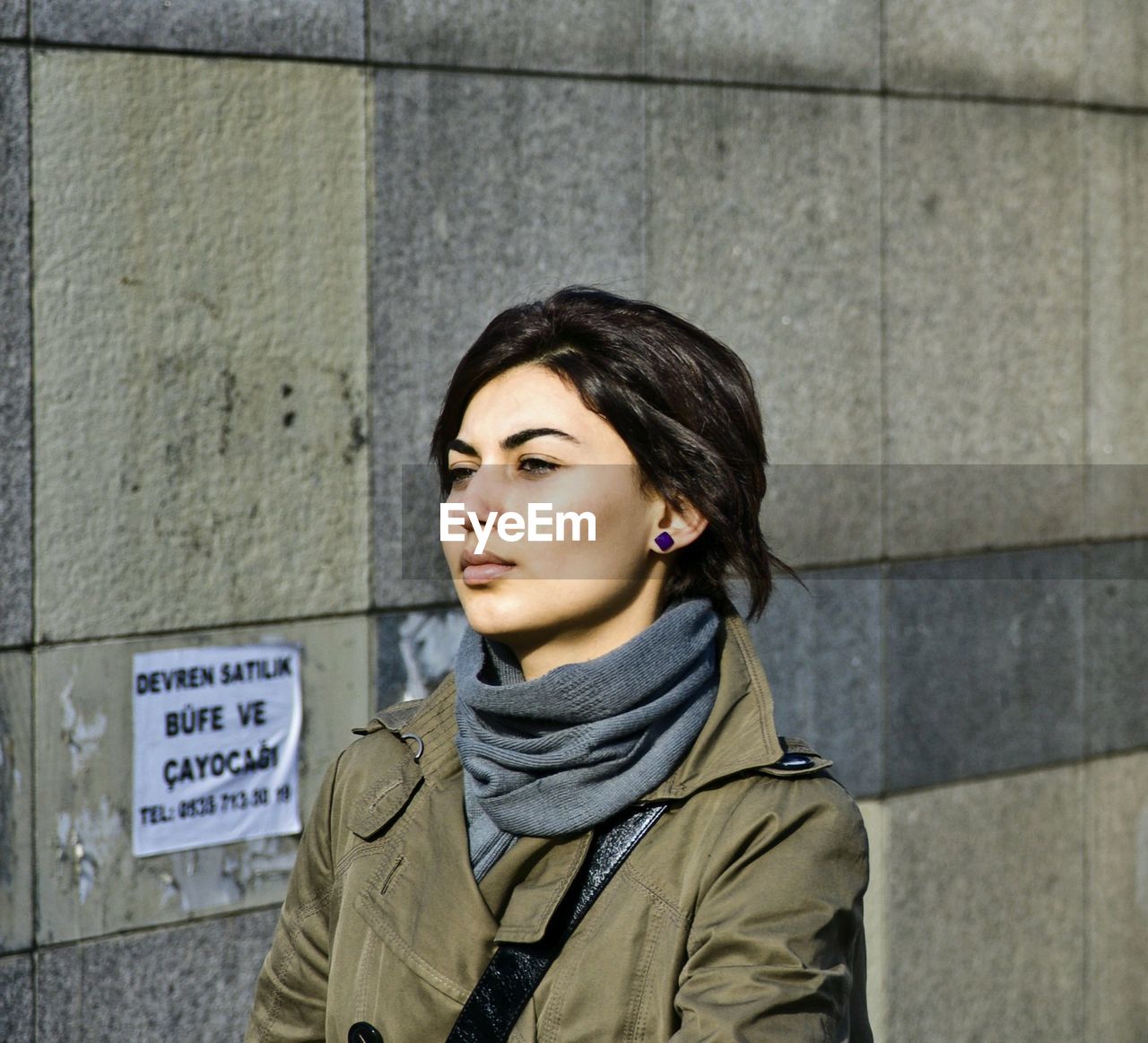 PORTRAIT OF YOUNG WOMAN STANDING IN FRONT OF SNOW