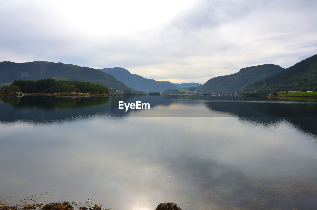 Scenic view of lake and mountains against sky