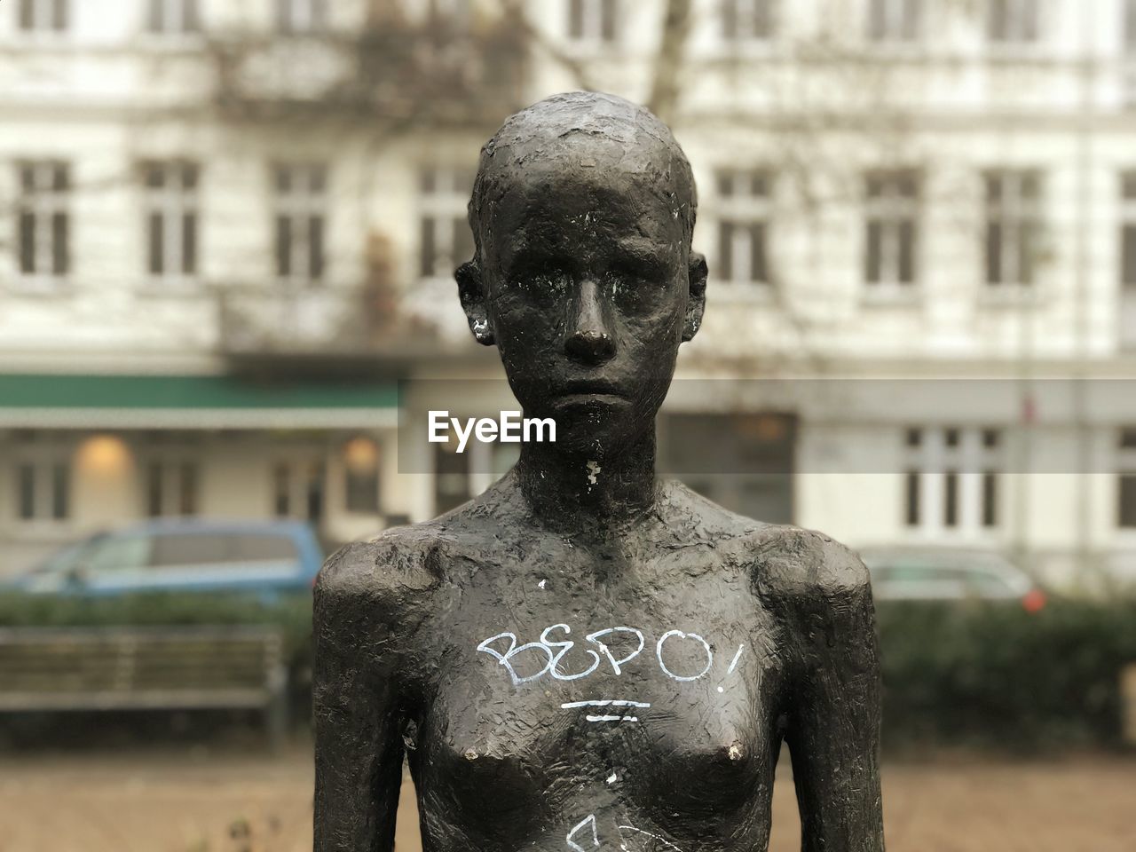 CLOSE-UP OF STATUE AGAINST BLURRED BACKGROUND