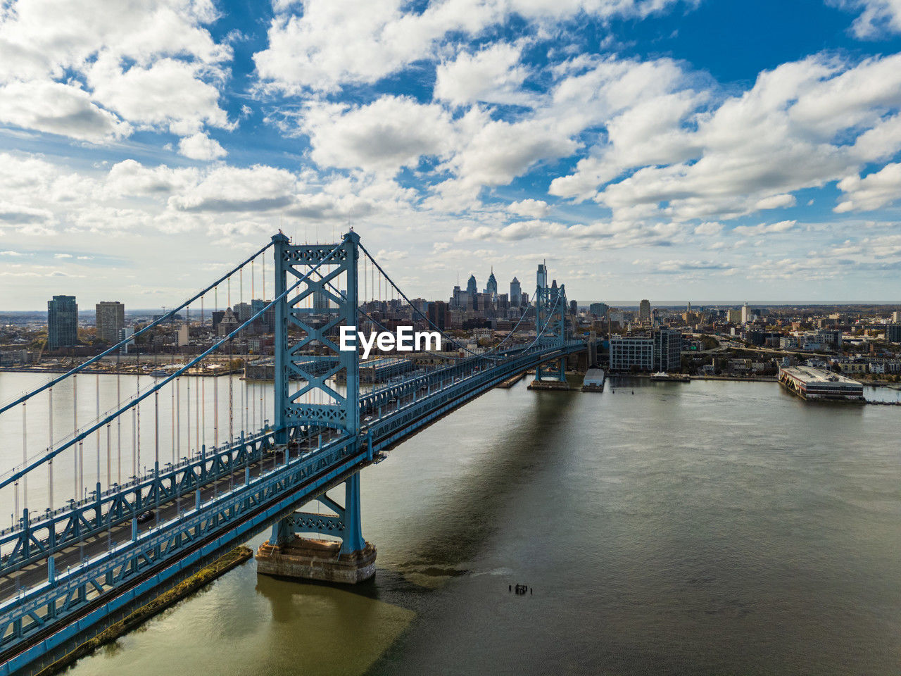 view of bridge over river against cloudy sky