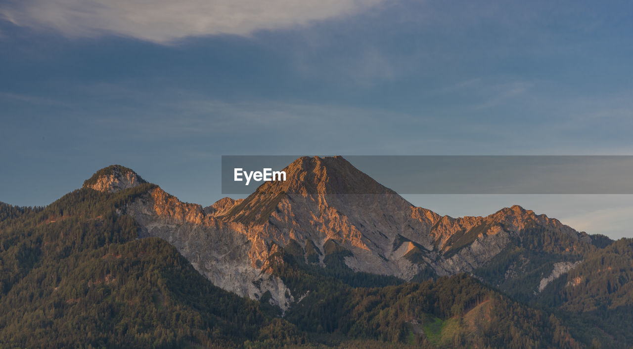 SCENIC VIEW OF MOUNTAINS AGAINST CLOUDY SKY