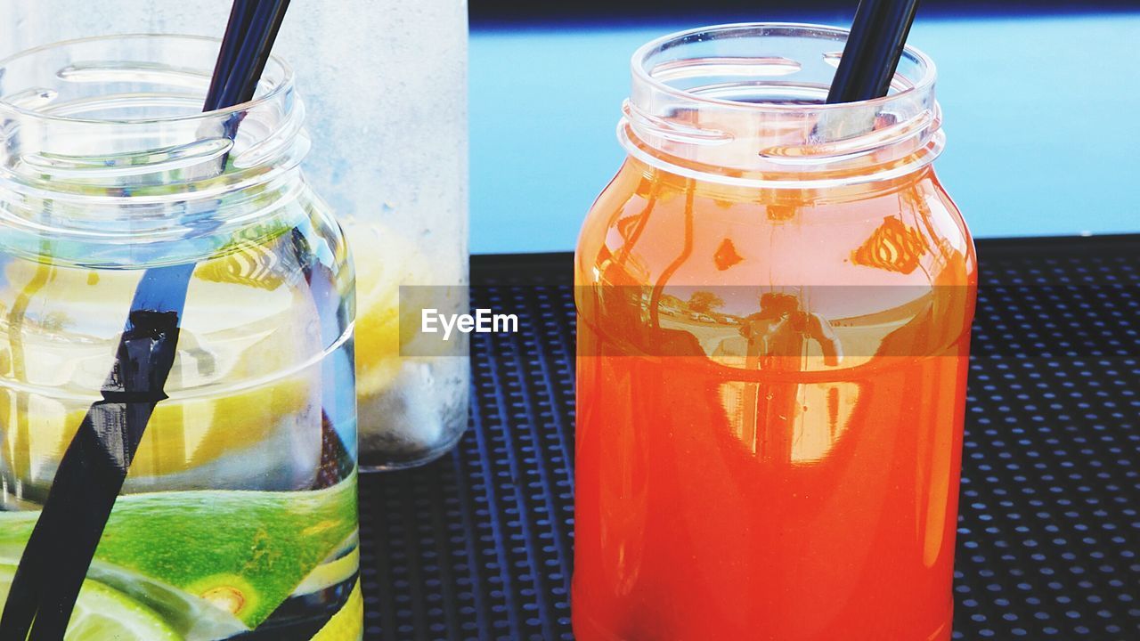 High angle view of fresh cocktails served in mason jars on table