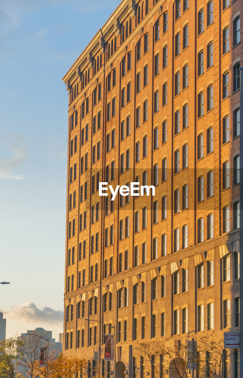 Low angle view of buildings against sky during sunset