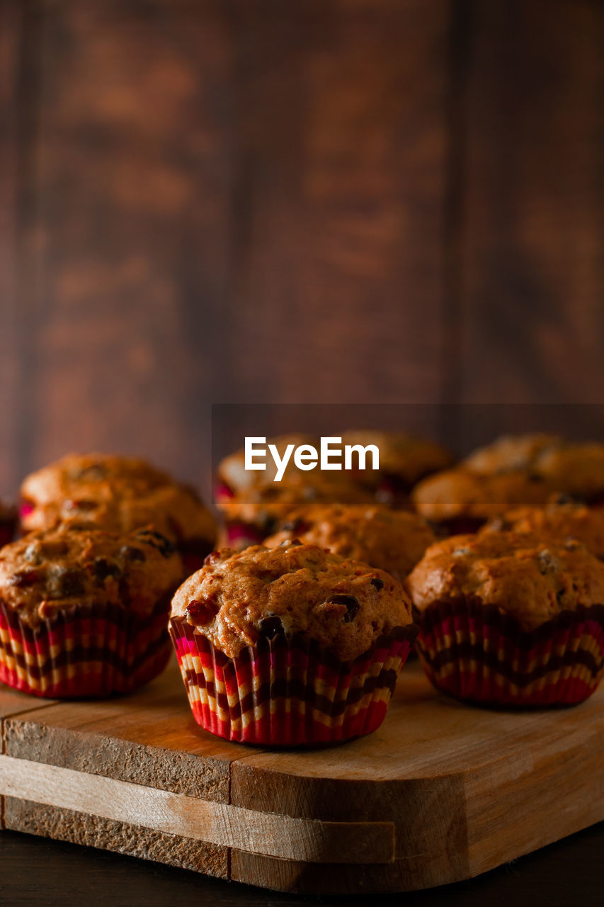 Appetizing muffins on a wooden cutting board. traditional pastries for the holiday.