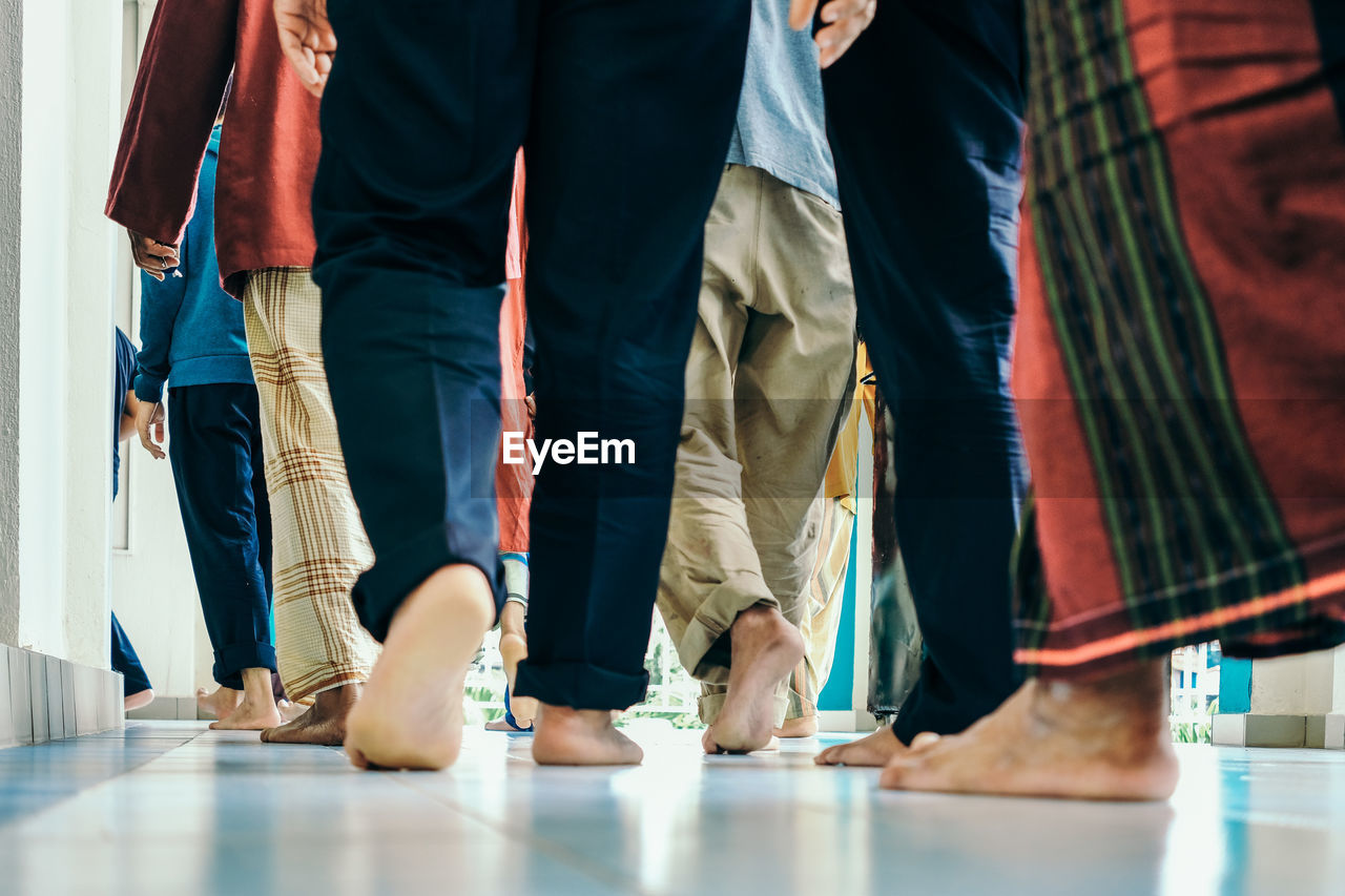 Low section of people on tiled floor