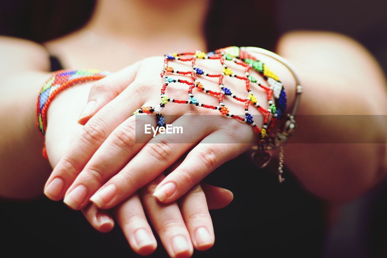 Close-up of woman wearing multi colored bracelet