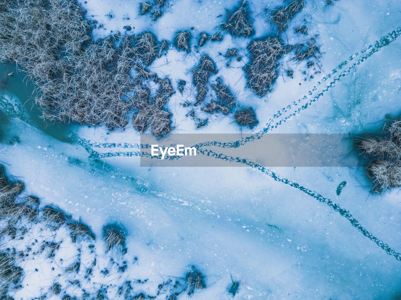Panoramic aerial view of a frozen lake with animal footprints. animal tracks on the frozen surface 