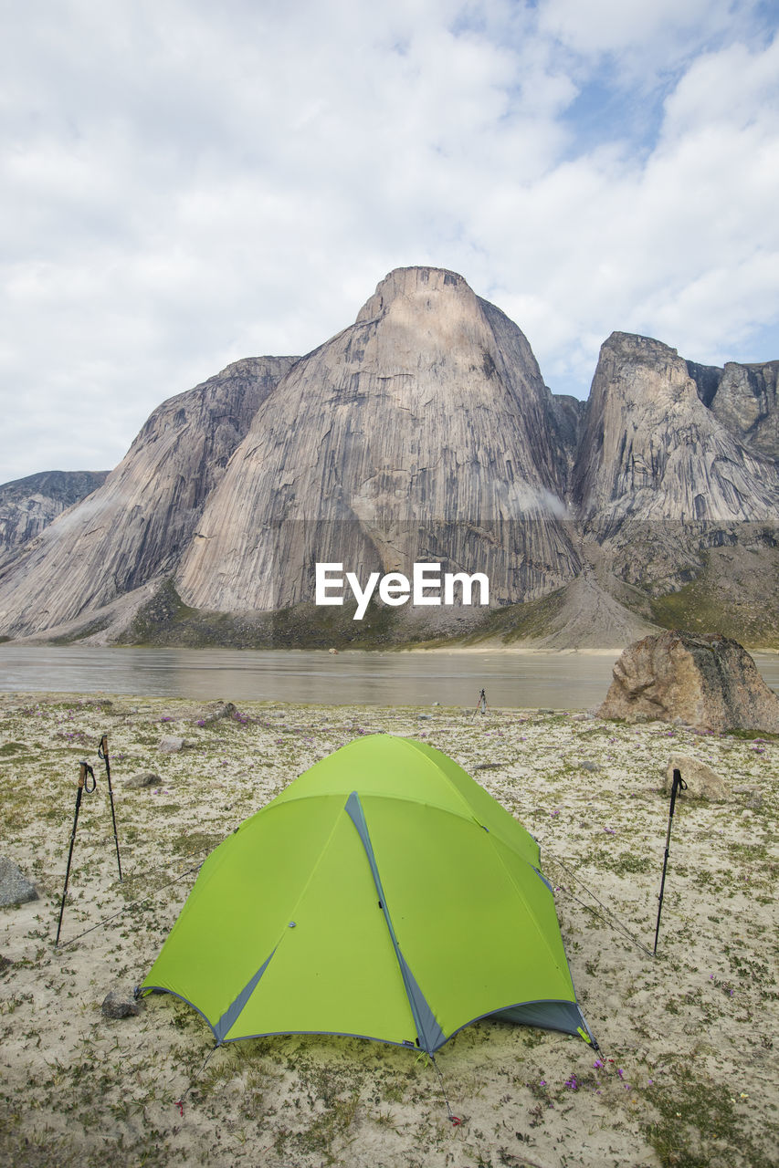 Tent pitched at rock climbers camp below stunning granite mountains.