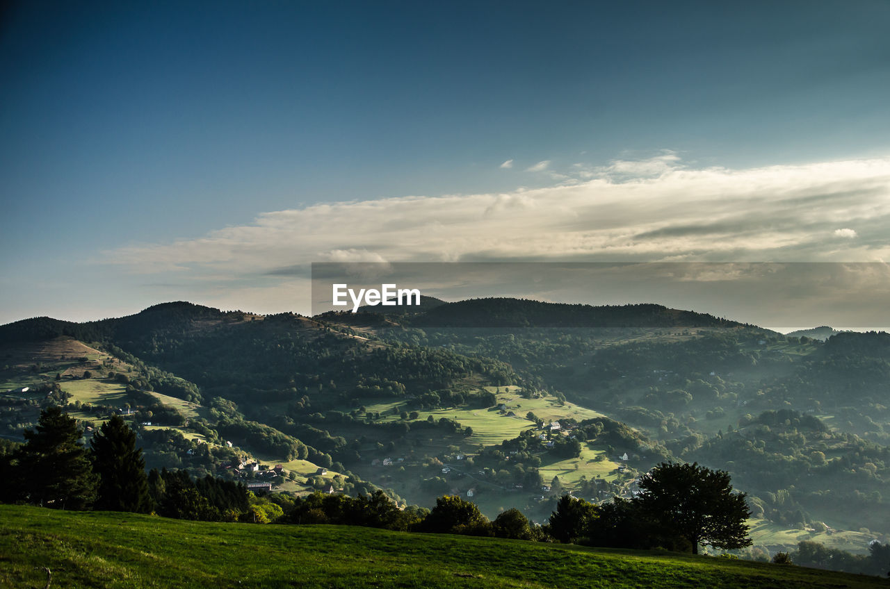 SCENIC SHOT OF LANDSCAPE AGAINST MOUNTAIN RANGE