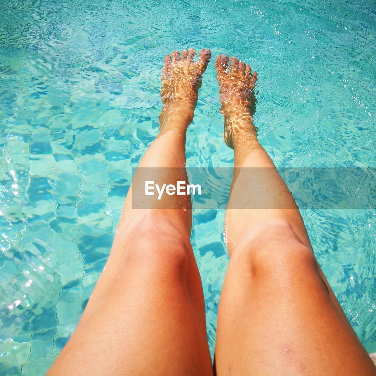 Low section of woman at swimming pool