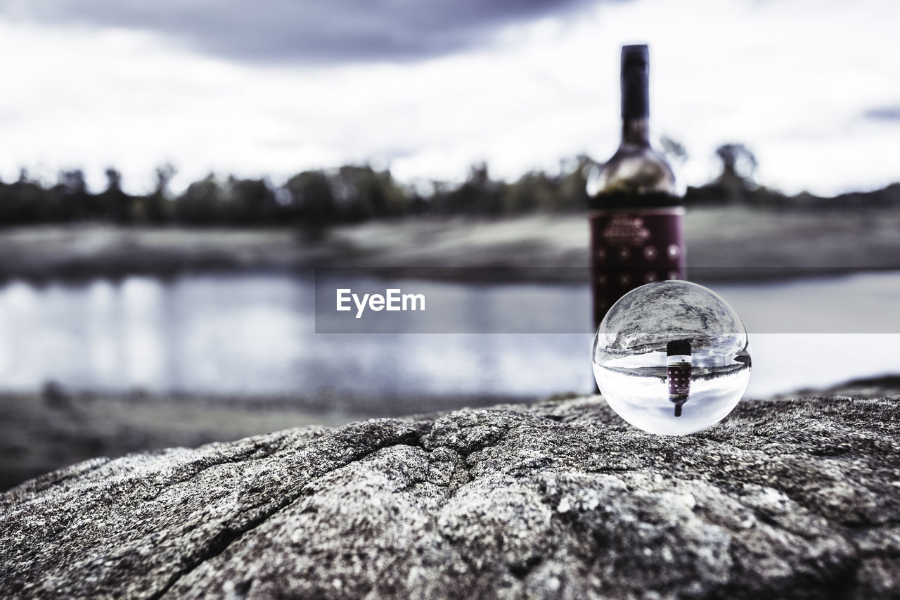 Wine bottle reflected inside glass ball