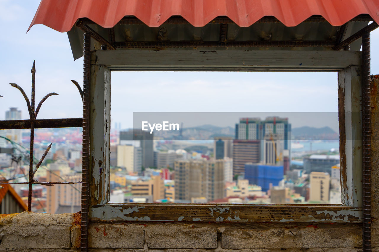 Buildings in city against sky framed