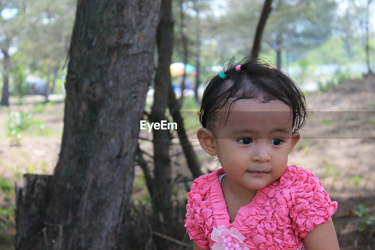 Cute girl sitting in forest