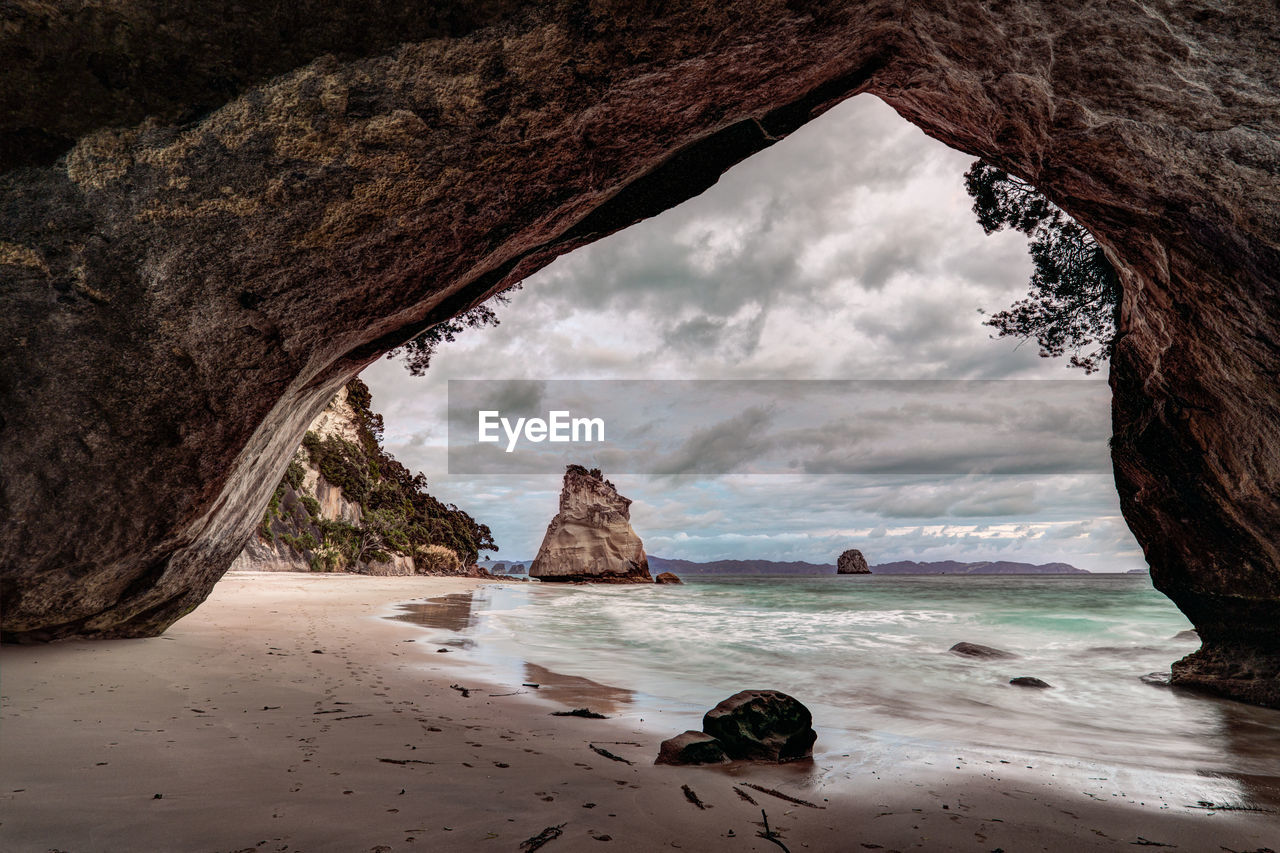 View of beach against cloudy sky