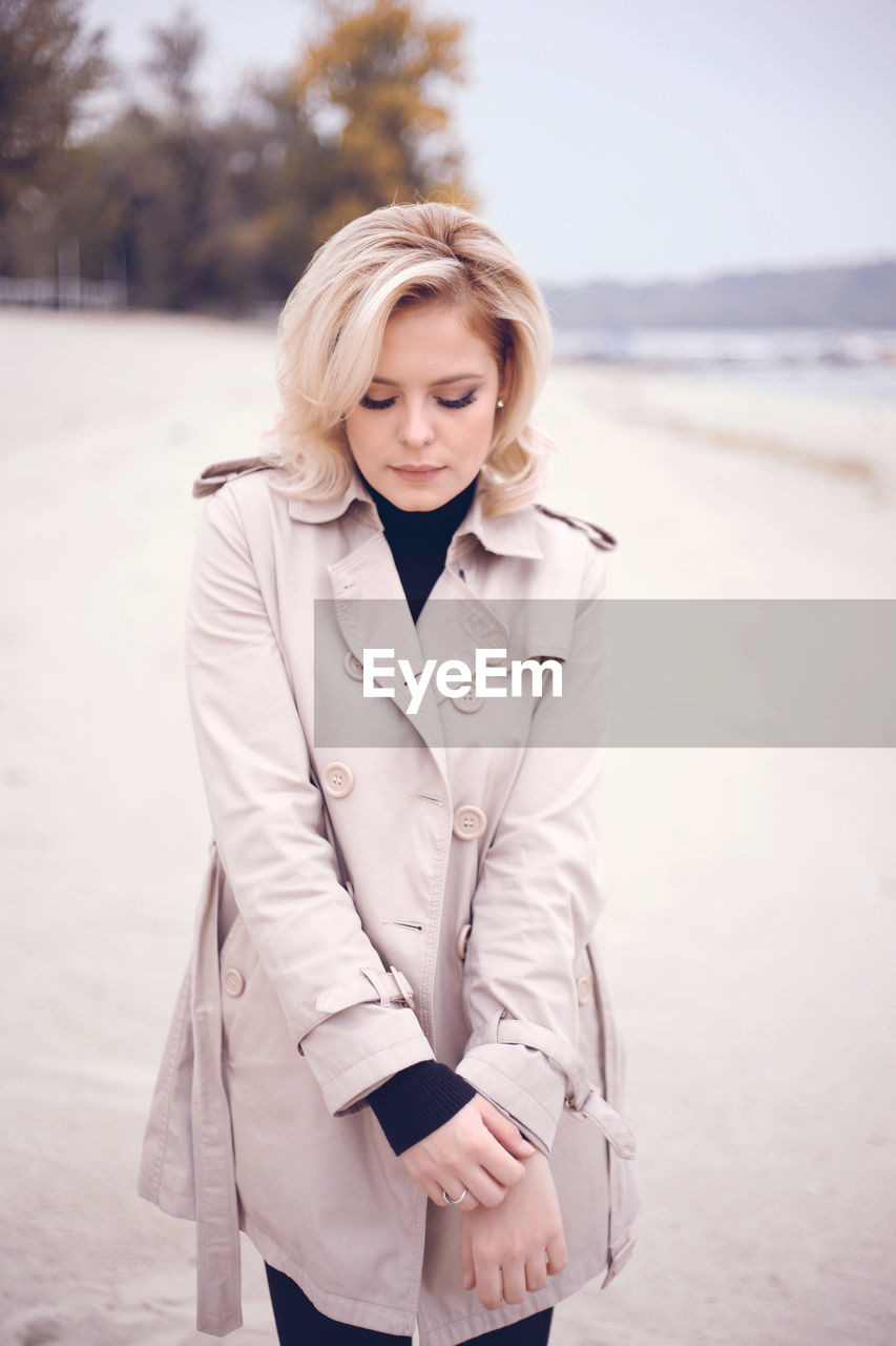 Beautiful woman standing at beach