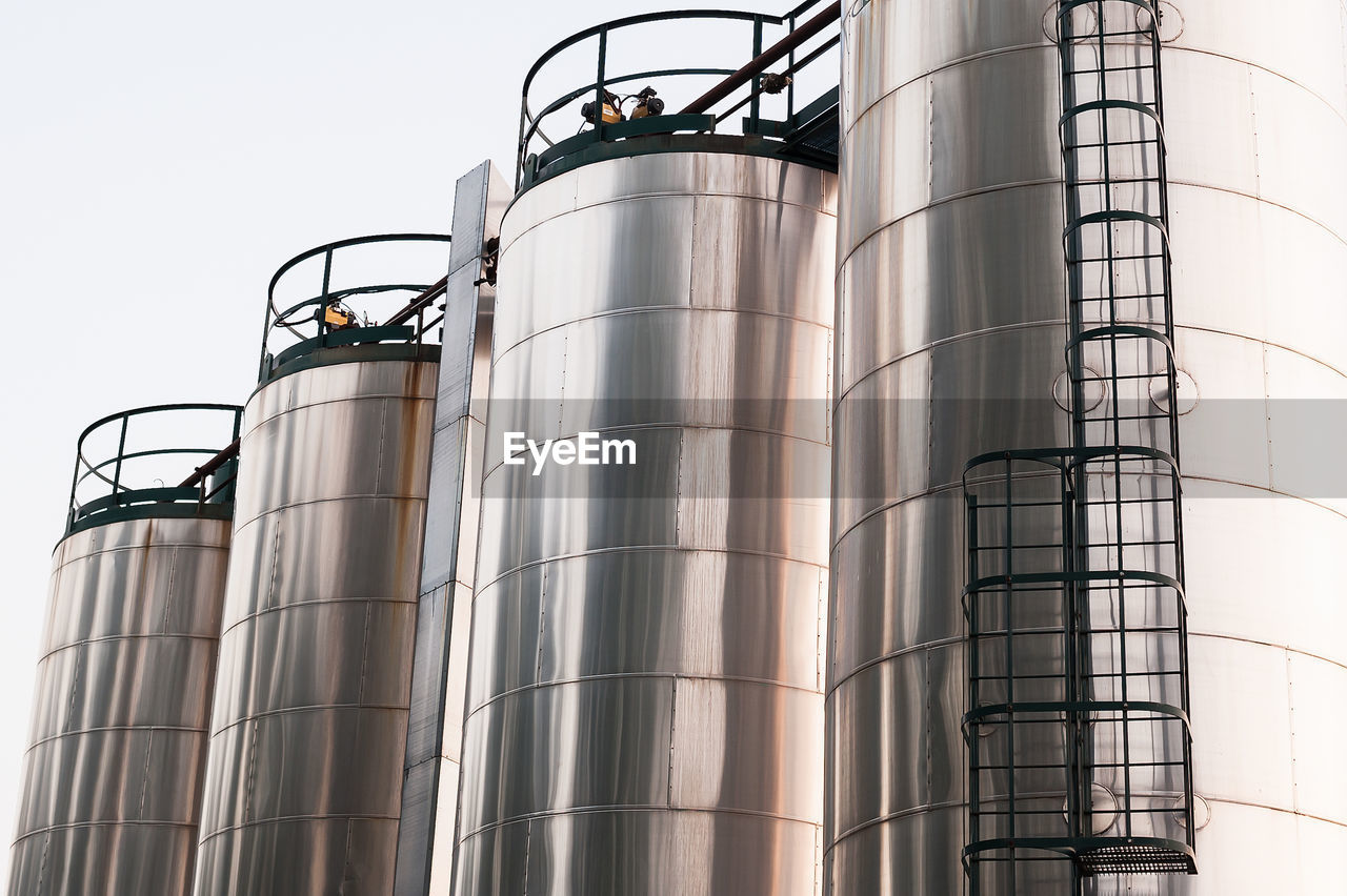 Low angle view of industry against clear sky