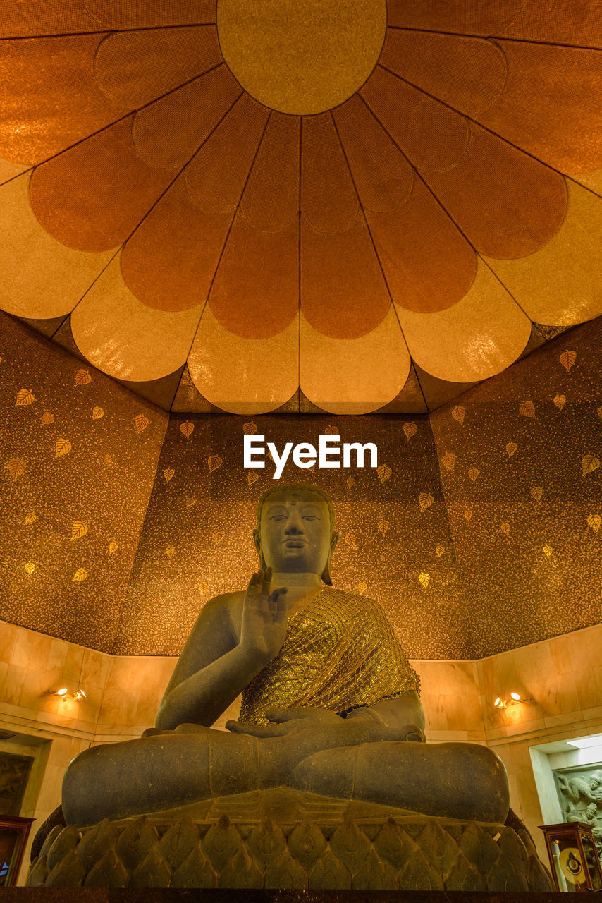 Low angle view of buddha statue in temple