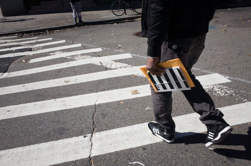 LOW SECTION OF PERSON STANDING ON ROAD