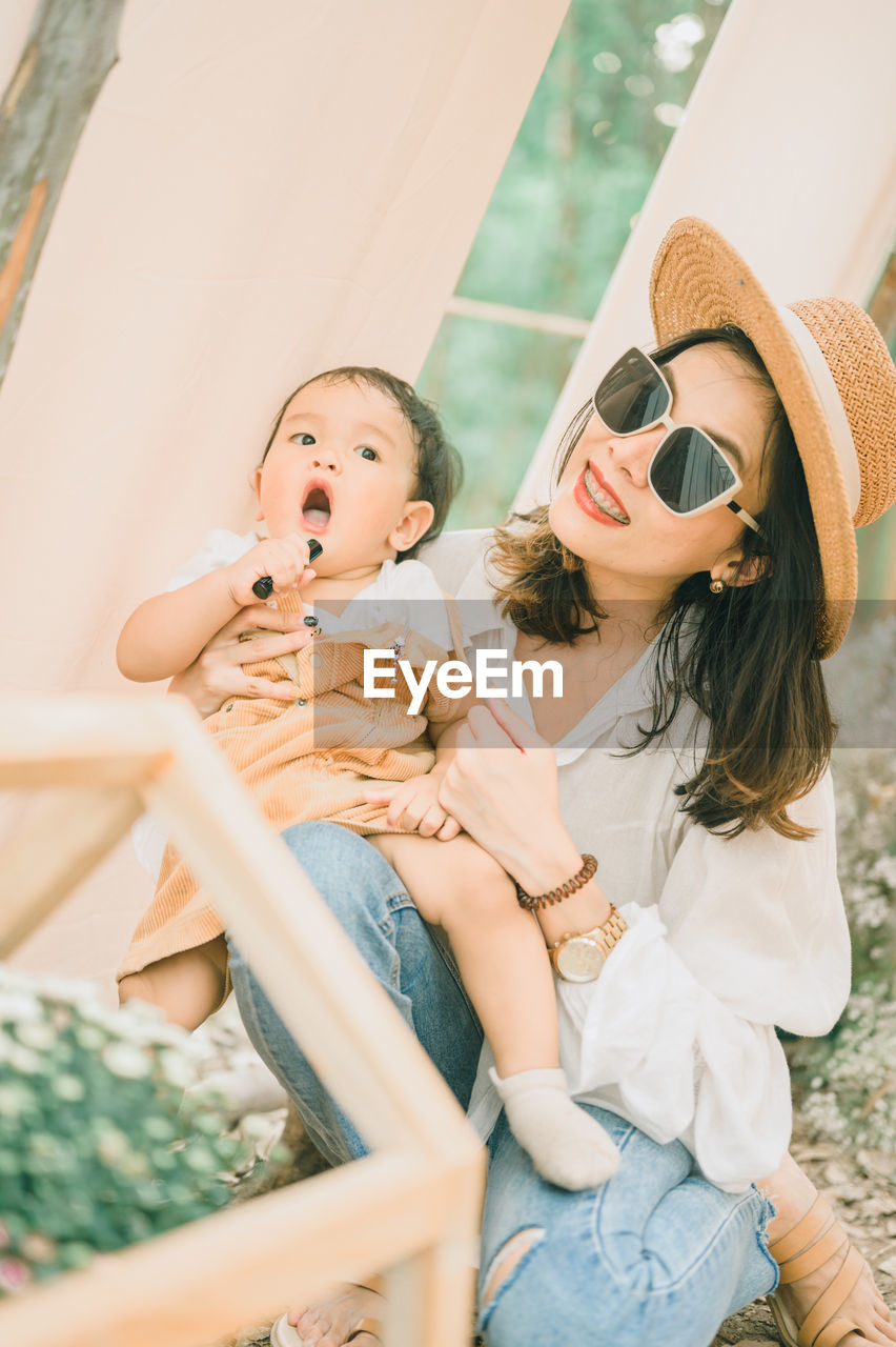 Smiling mother with baby enjoying outdoors