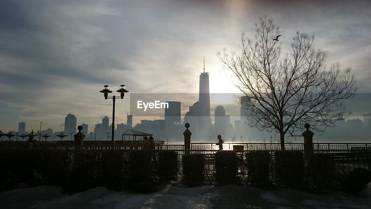 East river against silhouette buildings at manhattan