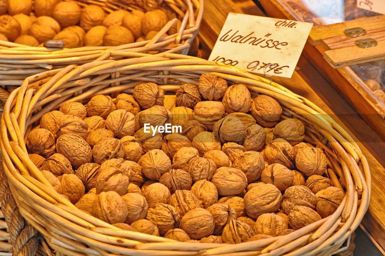 High angle view of walnuts in wicker basket at store for sale