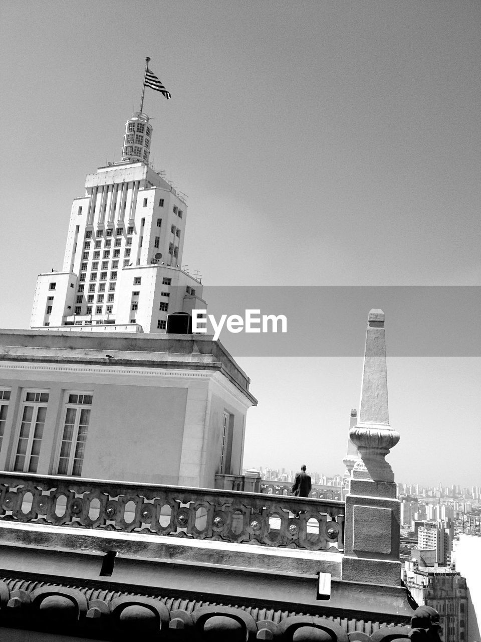 Rear view of man standing on building terrace