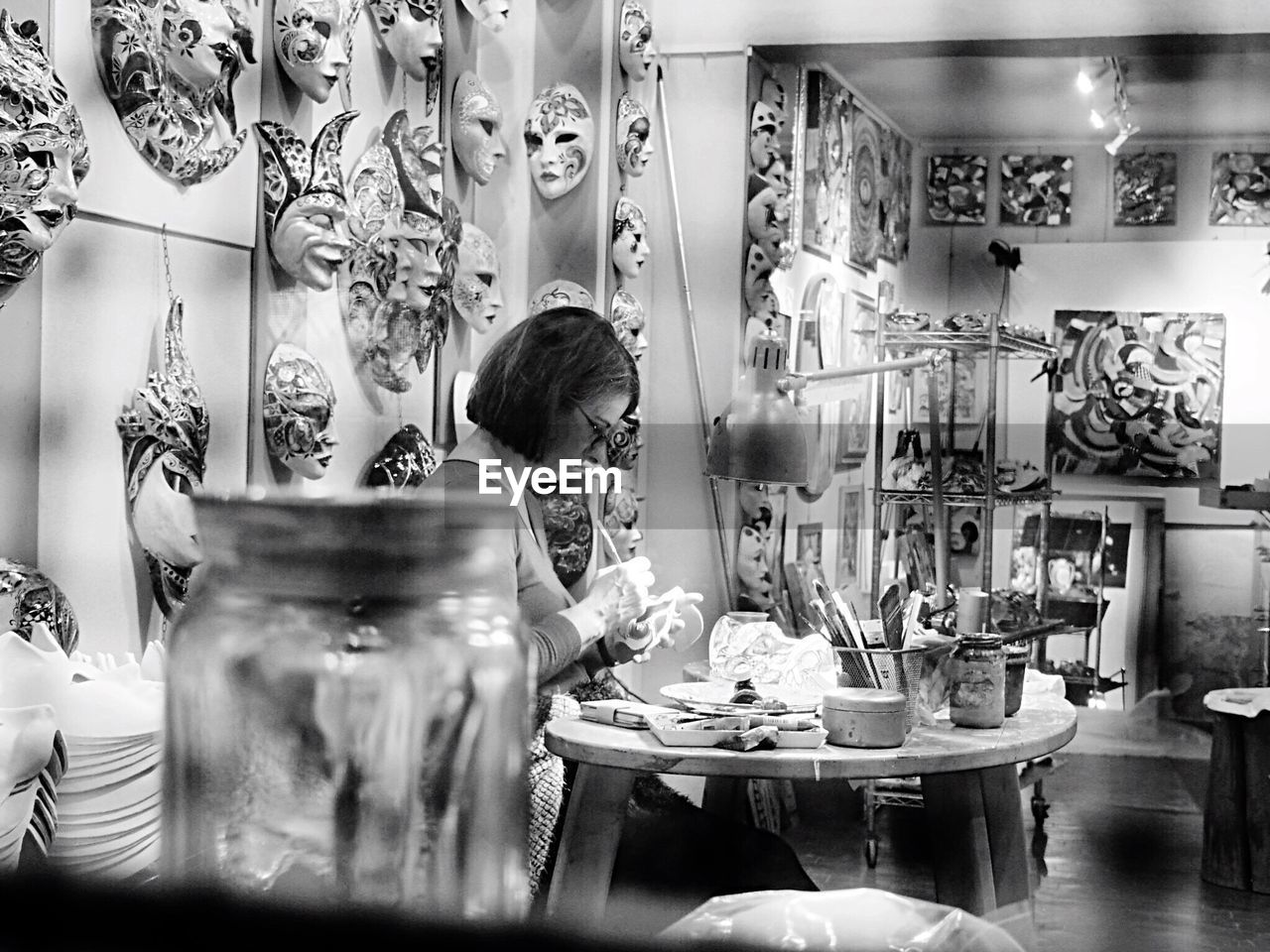 WOMAN DRINKING GLASS WITH TABLE