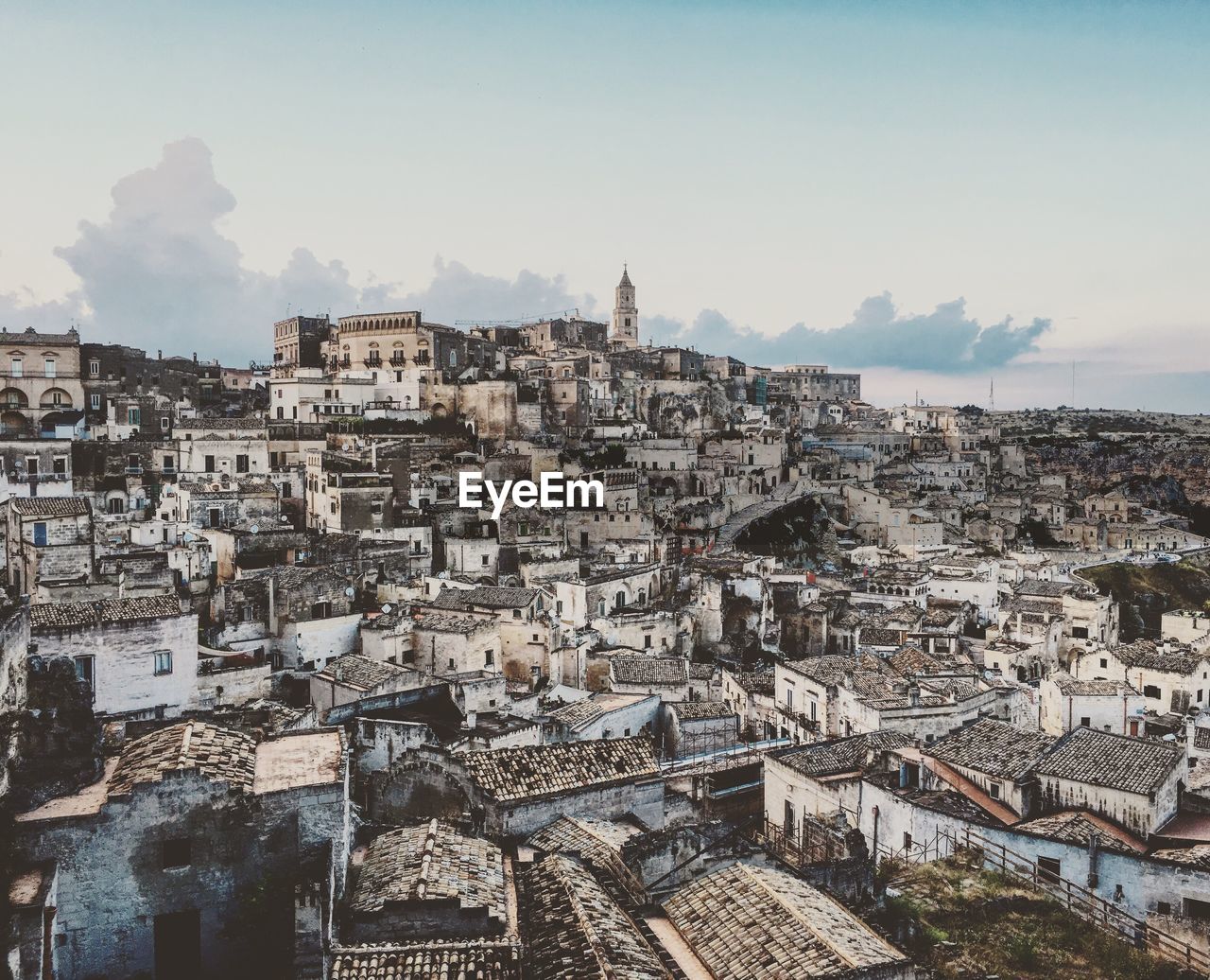 Cityscape against cloudy sky