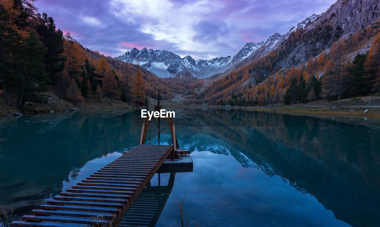 Scenic view of lake and mountains against sky