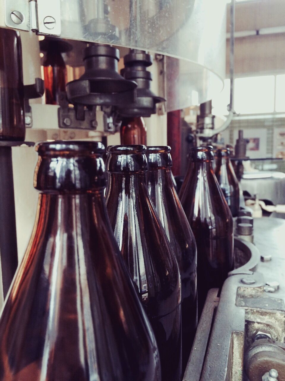 Close-up of bottles in machine