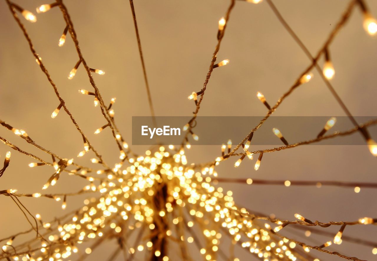 Illuminated christmas lights against ceiling