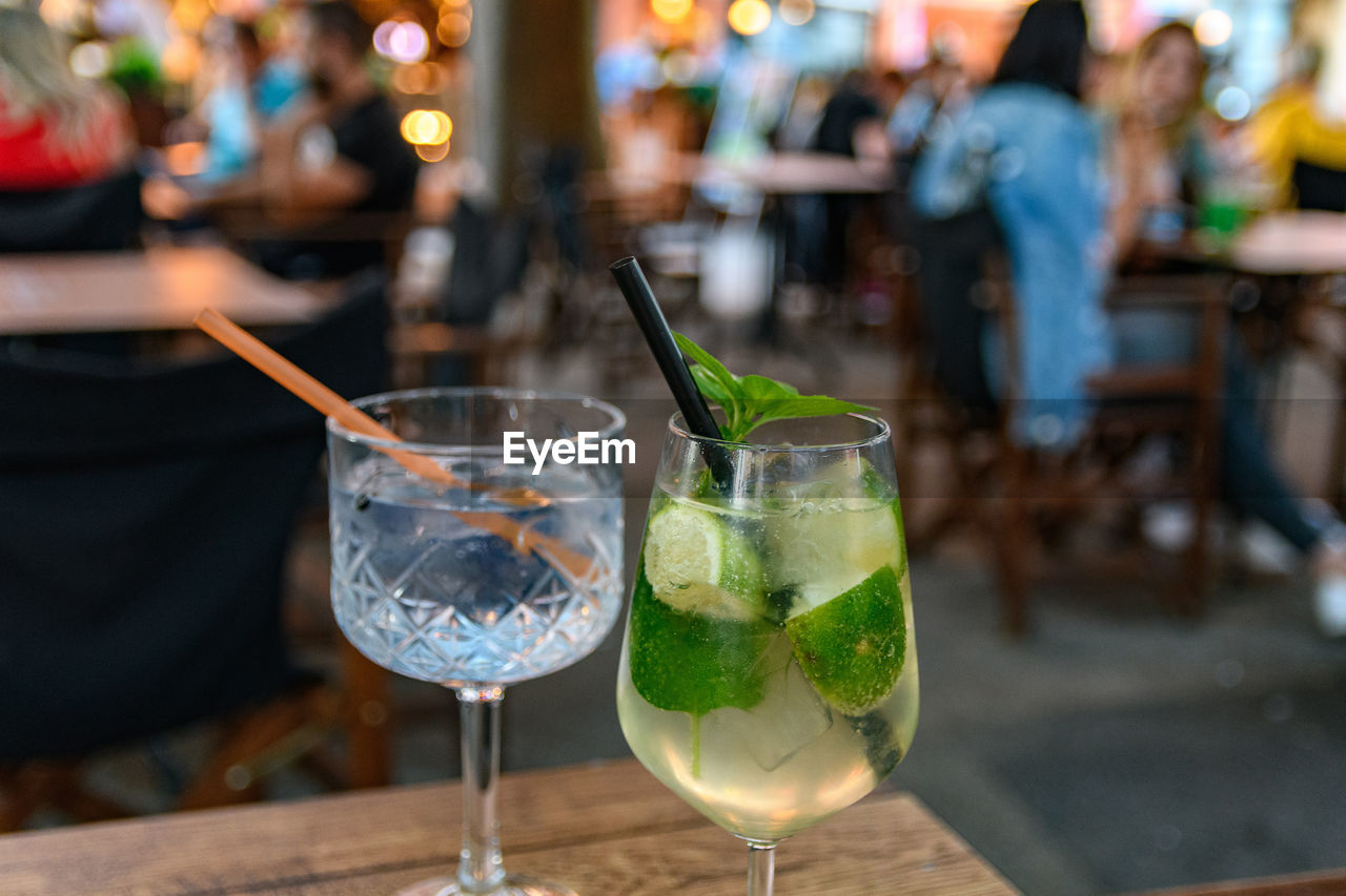 Close-up of refreshing cocktail and gin tonic on table in bar in city