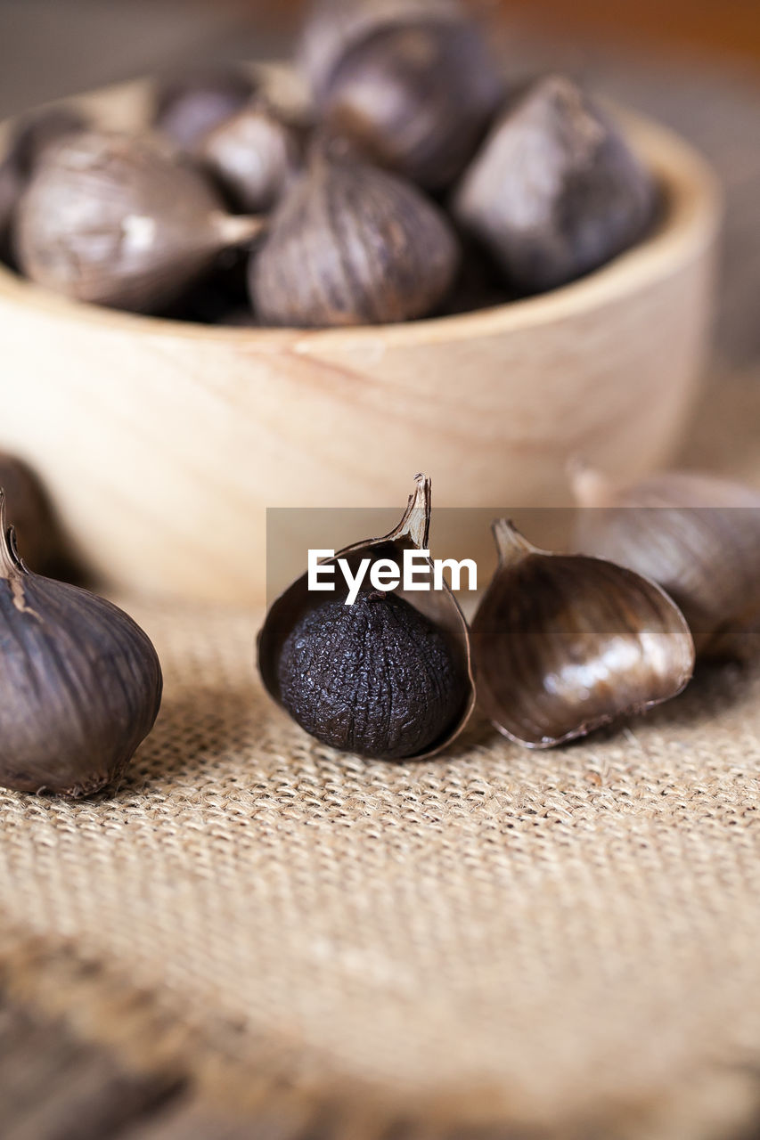 Black garlic on sack cloth and wooden table