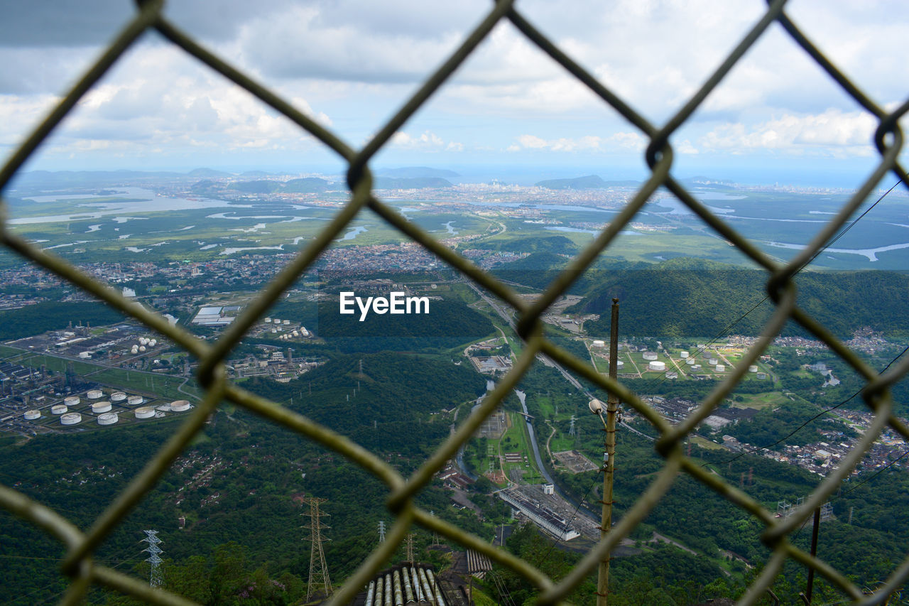 Scenic view of landscape seen through chainlink fence