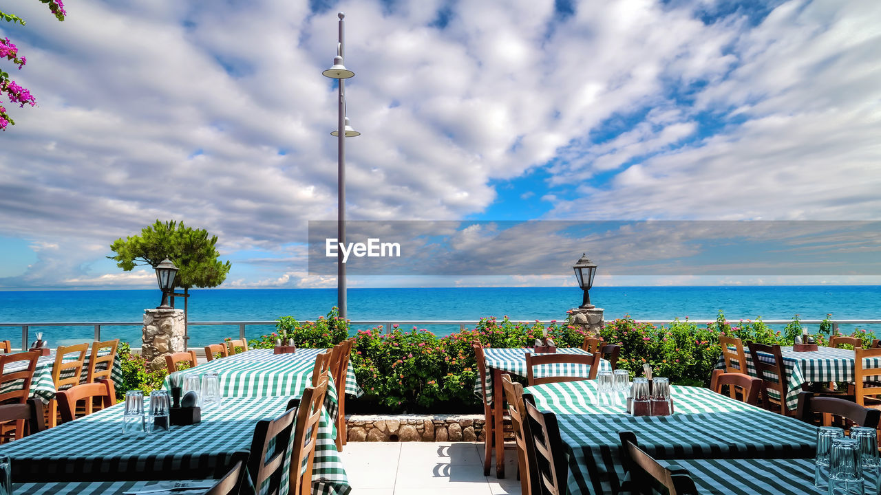 Cyprus sea coast and typical restaurant terrace under sunny cloudy sky in the morning 