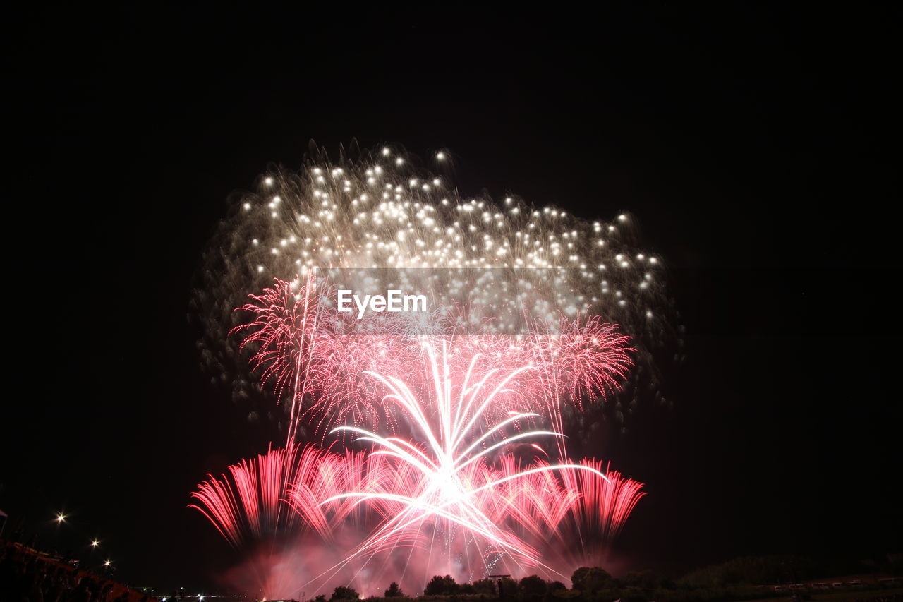 Low angle view of firework display at night