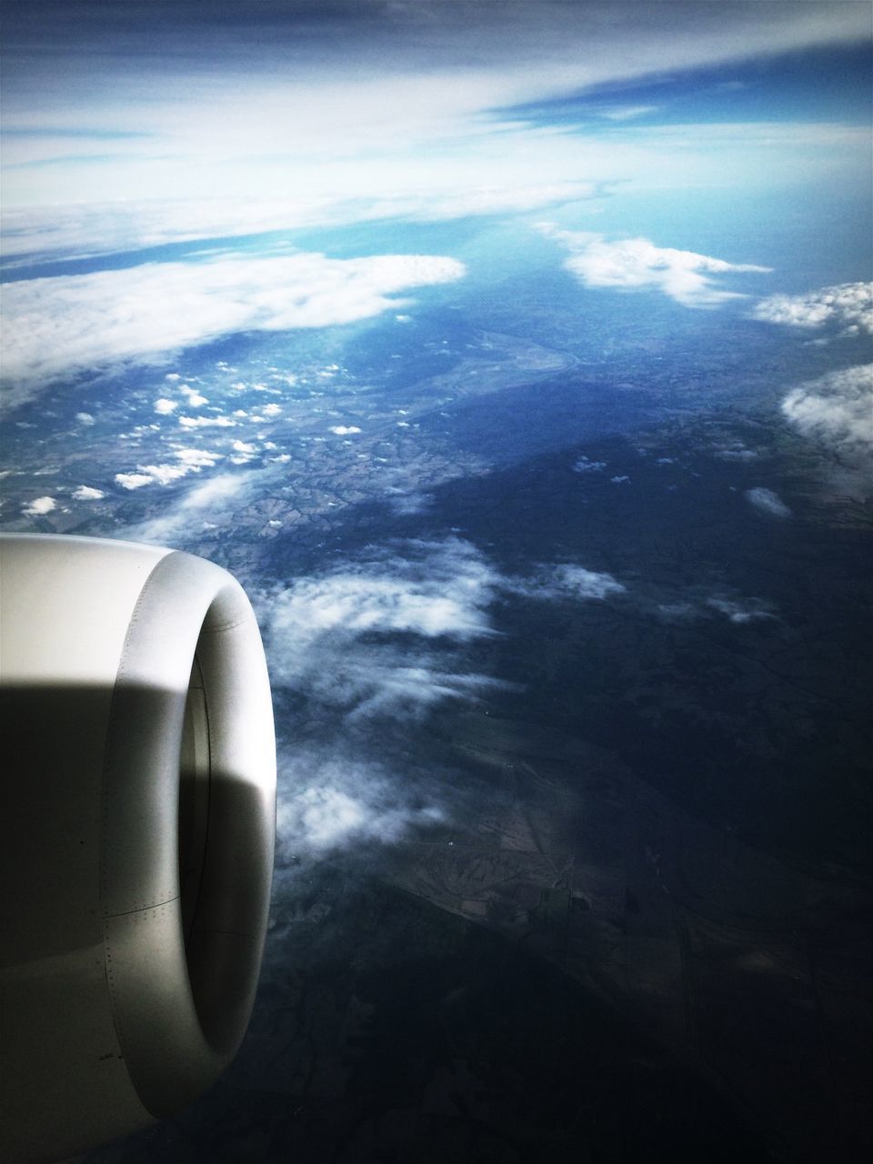 View of airplane jet engine above clouds