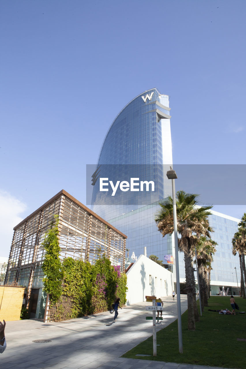 STREET BY BUILDING AGAINST CLEAR SKY