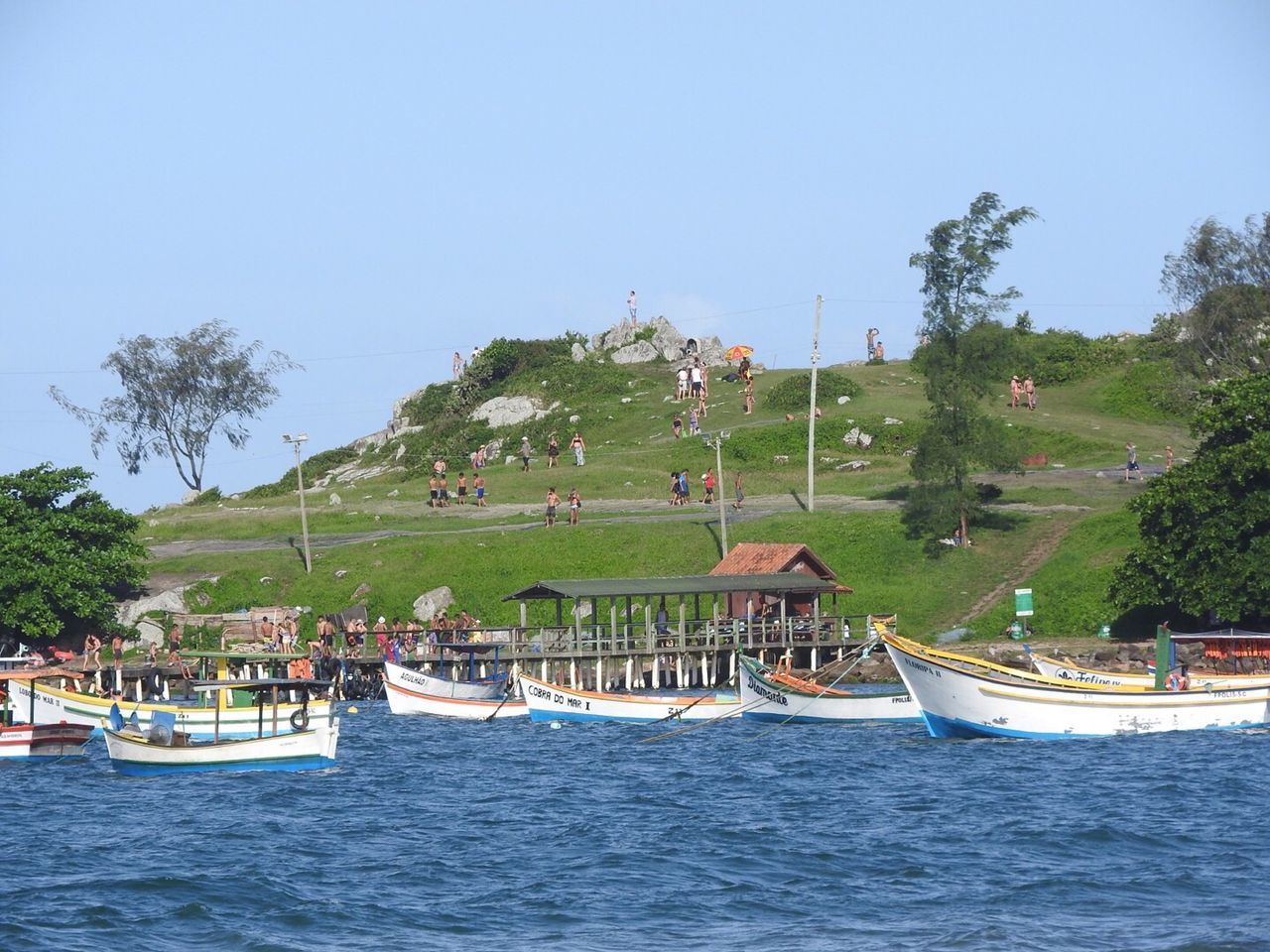 BOATS IN SEA WITH BUILDINGS IN BACKGROUND