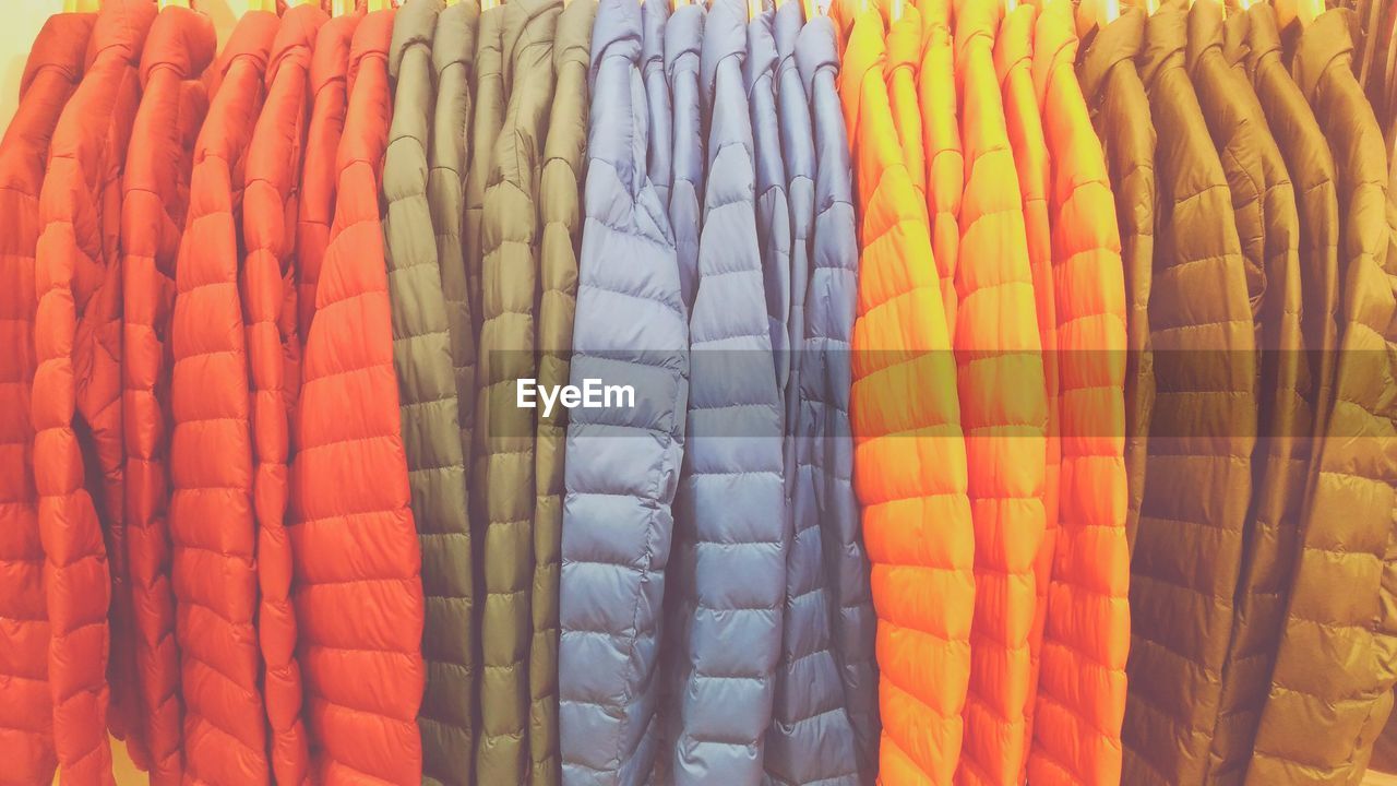 Full frame shot of colorful jackets for sale in clothing store