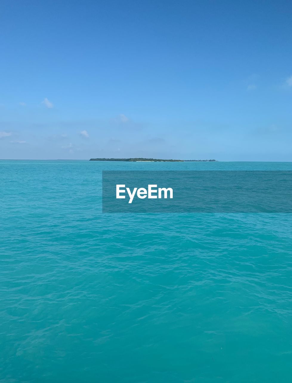 Scenic view of sea against blue sky