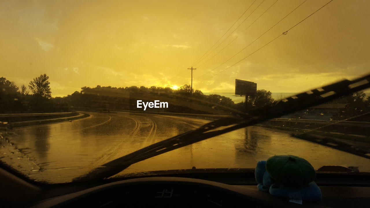 ROAD AGAINST SKY SEEN THROUGH WINDSHIELD