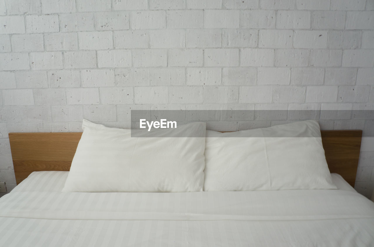 Bed against wall at home